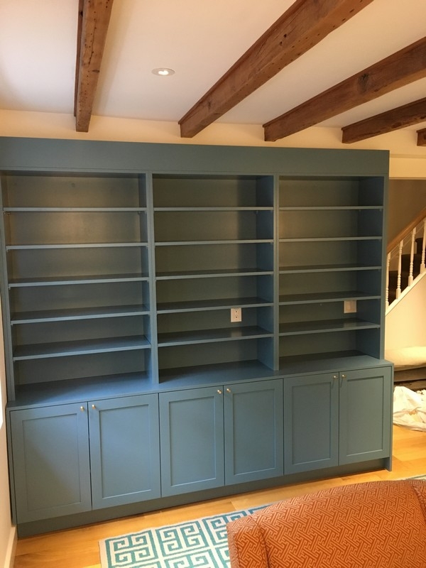 Large, custom-made bookcase unit in a sleek dark color, offering spacious storage solutions for contemporary spaces.  