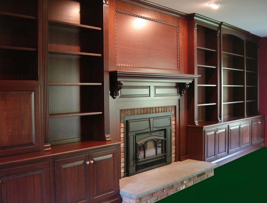 Spacious, full-wall custom bookcase unit in a sleek, modern design with natural wood color shelves.  