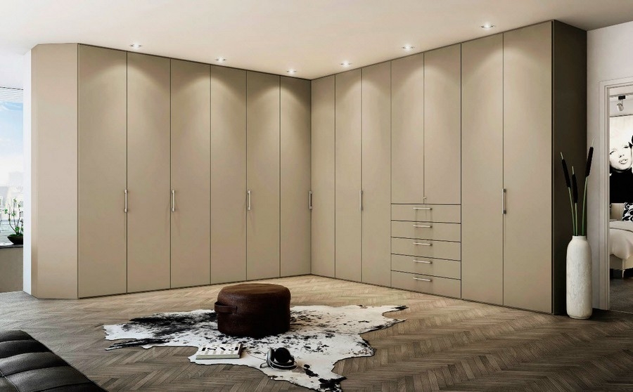 Large, custom-built wardrobe with full wall cabinets in a sleek, modern design.             