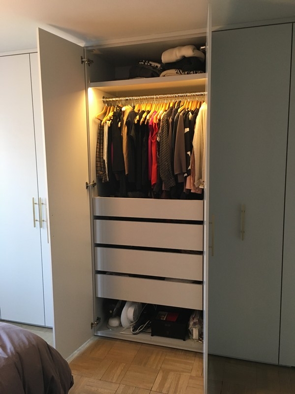 Sleek, custom-designed wardrobe with large, wood cabinets in a natural tone.             