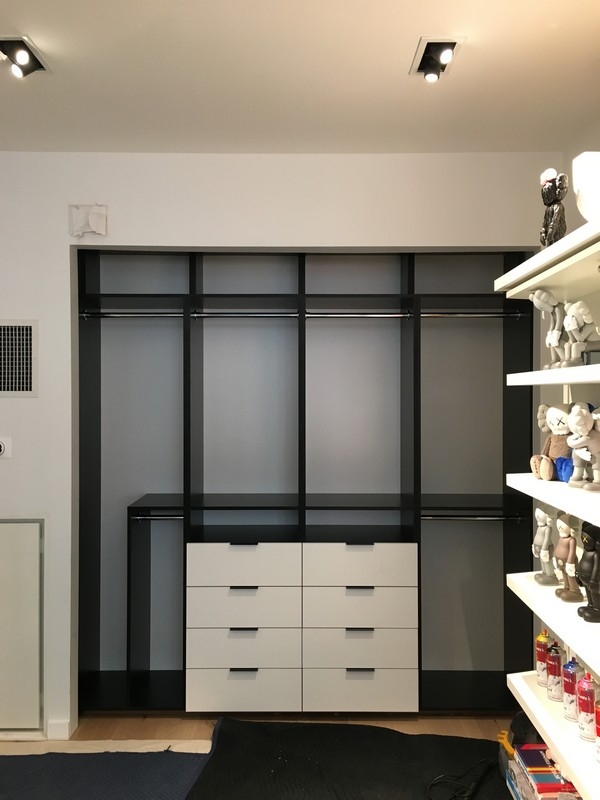 Sleek, custom-made wardrobe with big, light-colored wood cabinets and a modern style.             