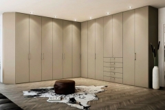 Large, custom-built wardrobe with full wall cabinets in a sleek, modern design.             