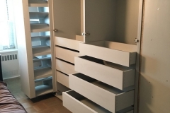 Custom-made, full wall wardrobe with large wood cabinets in a modern hazelnut color.             