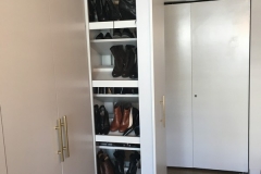 Custom, elegant wardrobe featuring spacious cabinets in a light, hazelnut color.            