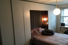 Contemporary, custom wardrobe with spacious, white cabinets and a sleek design.             