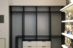 Sleek, custom-made wardrobe with big, light-colored wood cabinets and a modern style.             