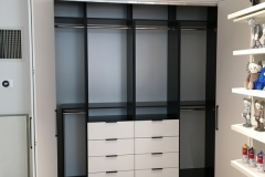 Elegant, built-in wardrobe custom-designed with spacious cabinets in a hazelnut tone.             