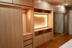 Spacious, custom wardrobe with full wall, white cabinets in a contemporary style.            