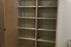 Sleek, full wall wardrobe custom-made with spacious cabinets in a hazelnut color.             