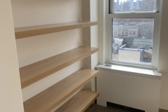 Contemporary, custom wardrobe with spacious, natural wood cabinets and a sleek finish.            