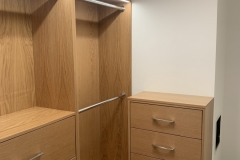 Spacious, custom-designed wardrobe with elegant, light wood cabinets.             S