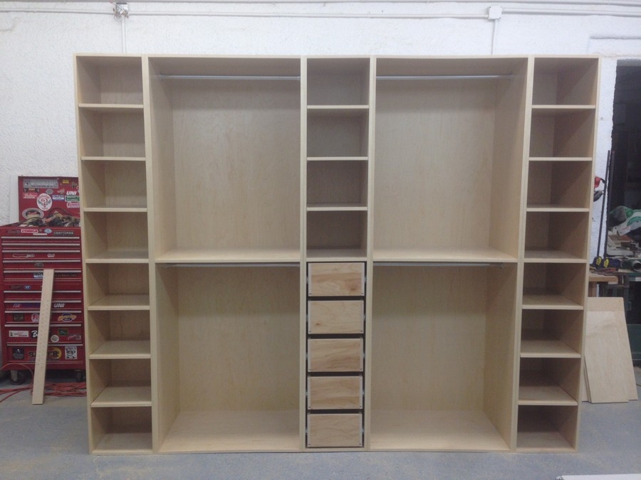 Elegant, full-room custom closet with built-in shelving in a warm hazelnut wood, designed for extensive storage and luxury.  