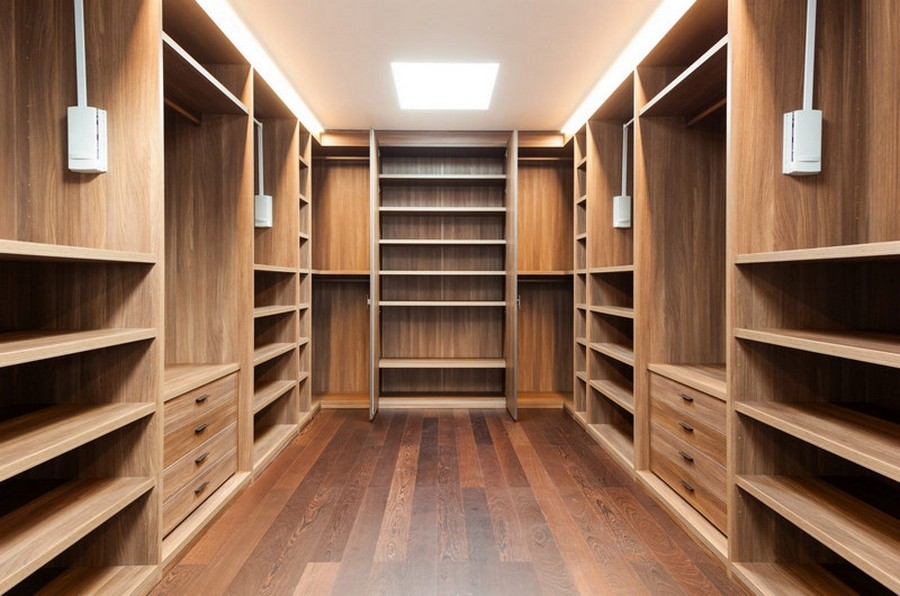 Elegant custom walk-in closet with built-in wooden cabinetry in a warm hazelnut color, offering expansive storage solutions.  
