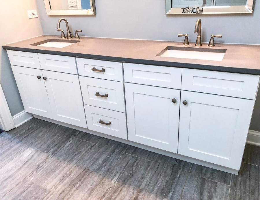a custom 2-sink vanity with white cabinets and brown top
