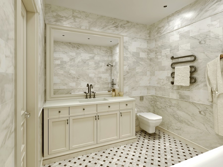 a large bathroom in light marble colors with a custom vanity