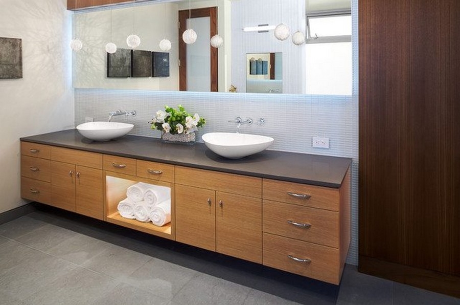 a big brown vanity with two bowl type white sinks