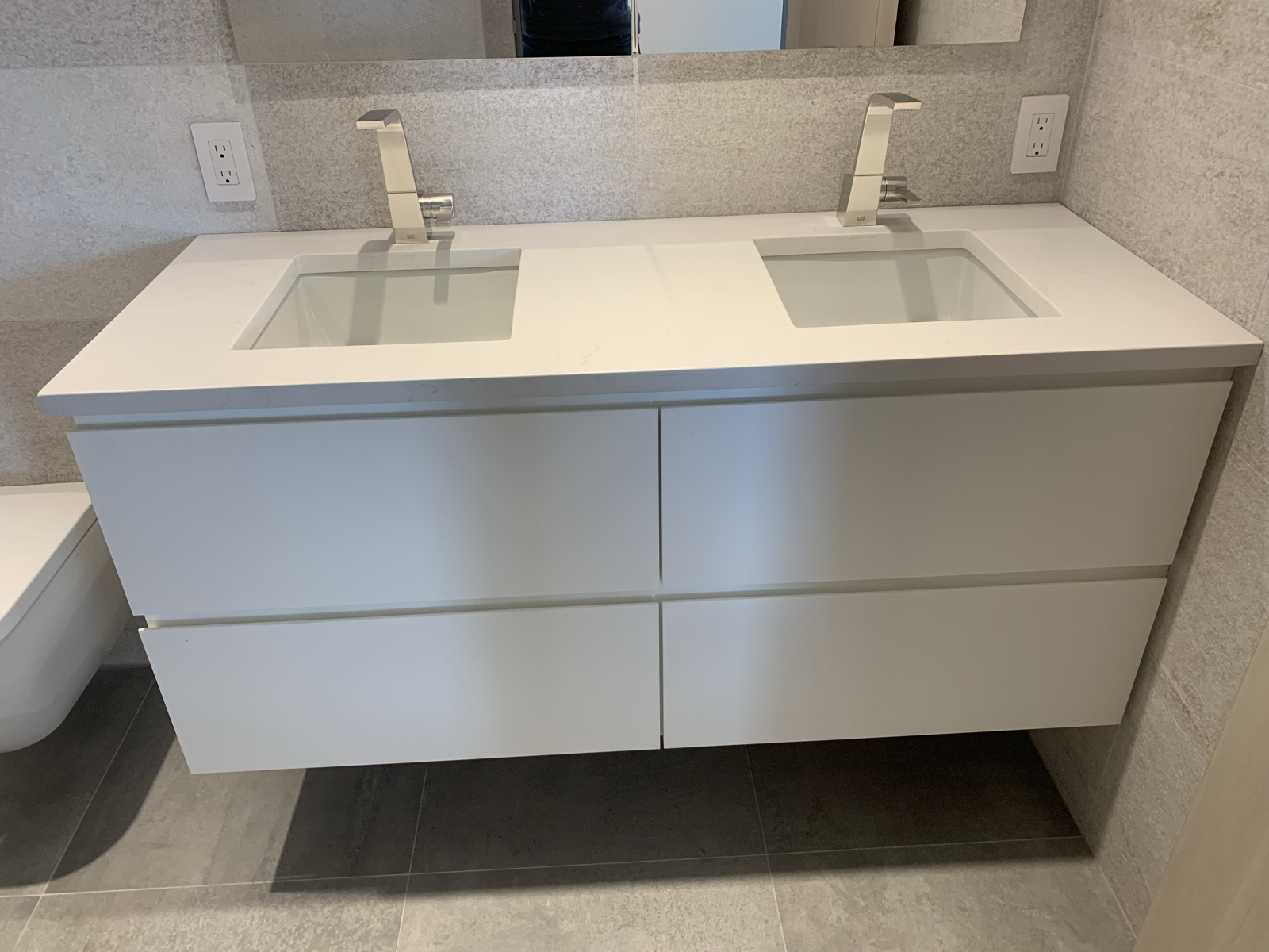 a small custom vanity with two rectangular sinks - front view