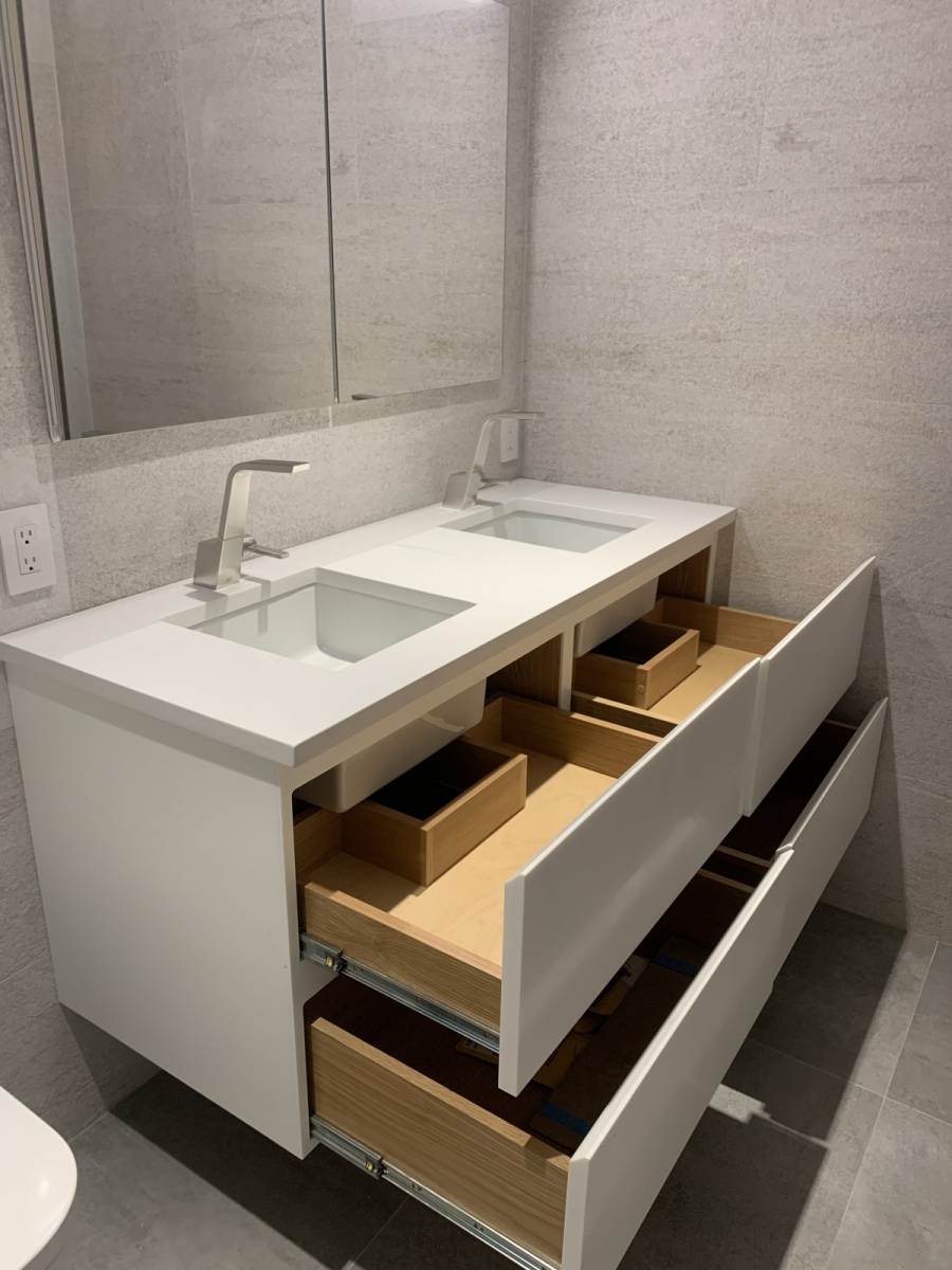 a small custom vanity with two rectangular sinks - open drawers