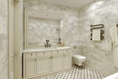 a large bathroom in light marble colors with a custom vanity