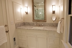 a bathroom in warm honey color with the same color vanity
