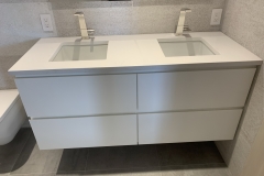 a small custom vanity with two rectangular sinks - front view