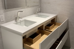 a small custom vanity with two rectangular sinks - open drawers
