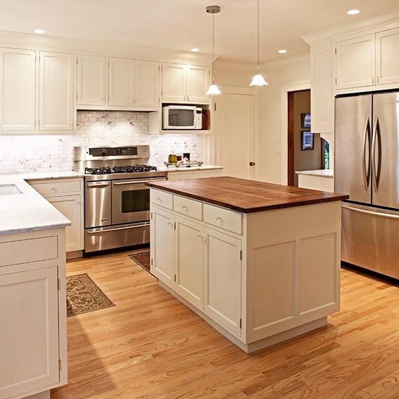 Elegant kitchen with custom-made spacious cabinets and a large, modern island.