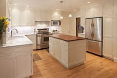Elegant kitchen with custom, spacious cabinets in a natural wood color and a contemporary design.